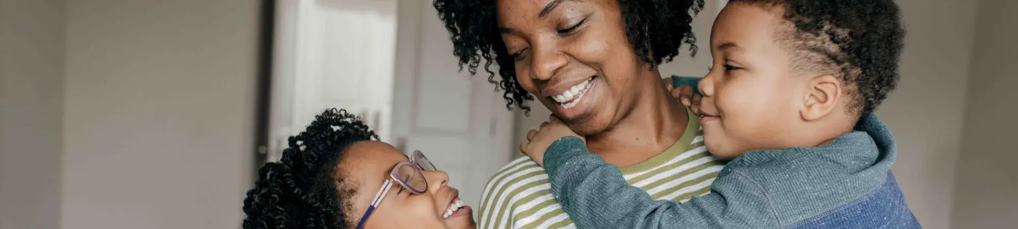 Mother and two kids smiling at each other