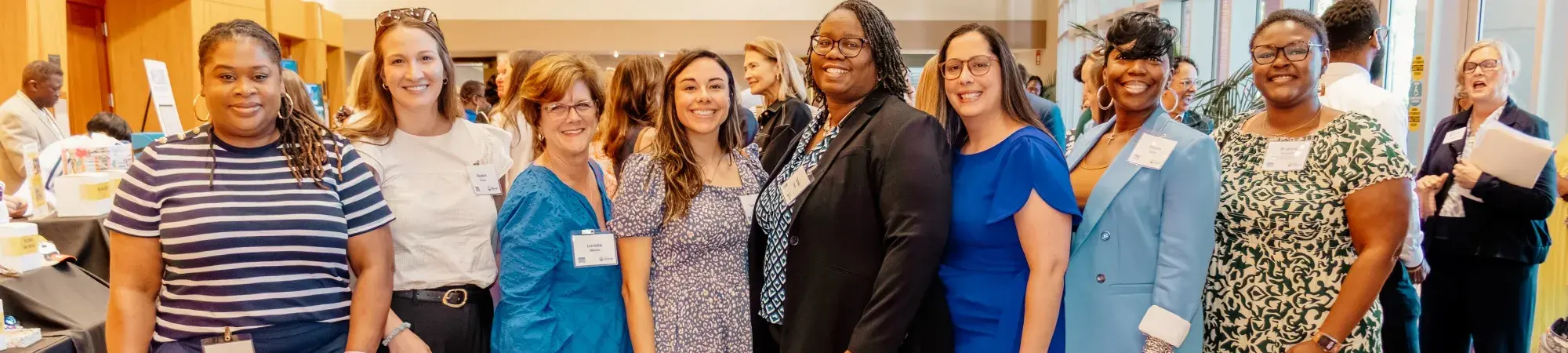 Group of 8 women posing for camera before the 2026 women united awards